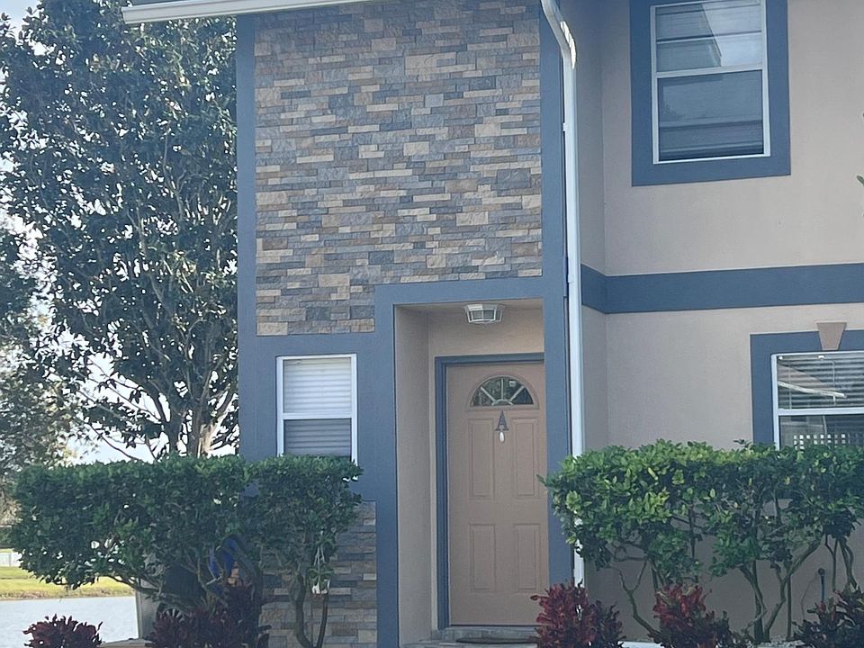 Freshly painted exterior with stacked stone accent and stone paver entrance.