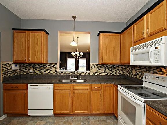 Counter and cabinet space galore! Plus convenient window overlooking the dining room and large living room.
