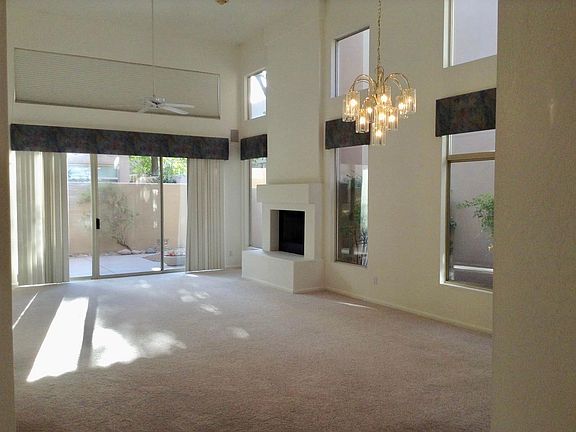 Living and dining area with sliding glass door to patio and backyard.
