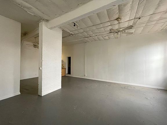 behind the brick pilaster there is a closet with a small sleeping loft above