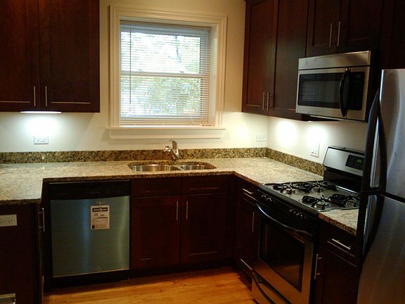 Similar kitchen shown with appliances.