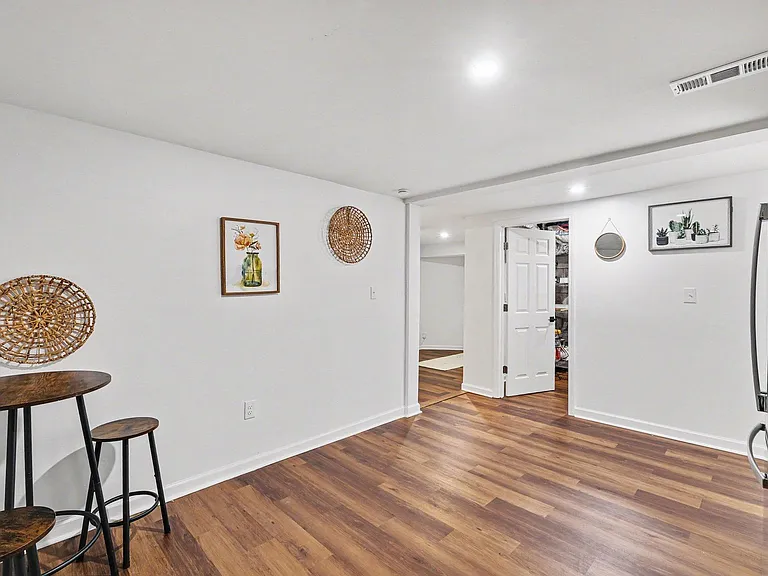 Open-concept dining nook with bar seating, durable wood-look floors, and easy flow into the kitchen and adjacent rooms.