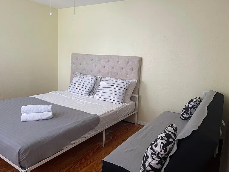 3rd bedroom with cotton bedding and queen bed and futon.