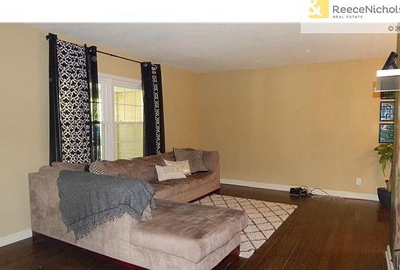 Living room with newer large window over looking front porch...