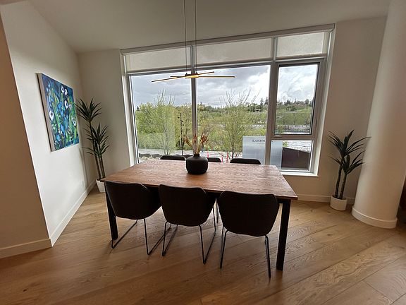 Dining room with dimmable LED dining light and expansive Bow River views.