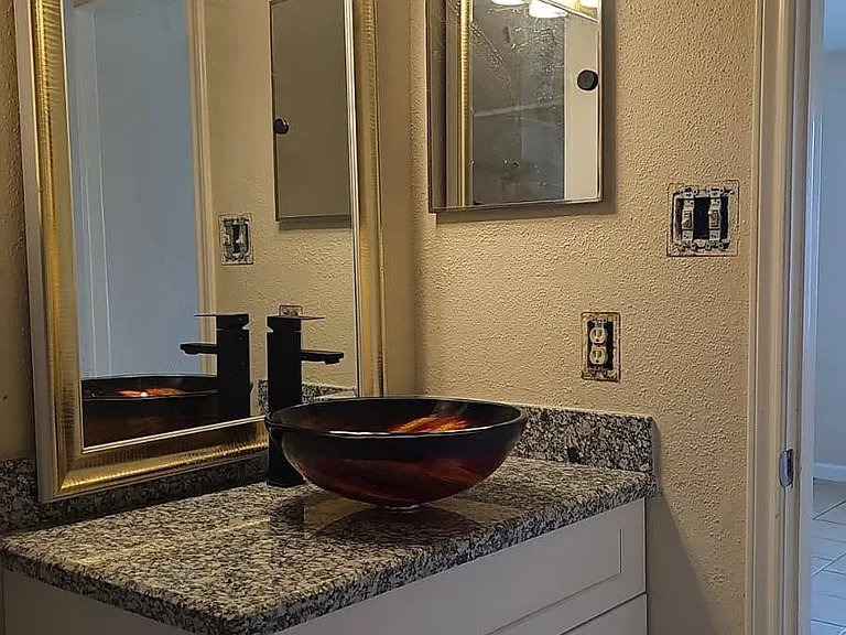Remodeled bathroom with granite counter, new vessel and hardware