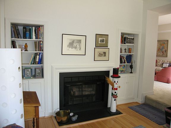 Den with wood burning fireplace