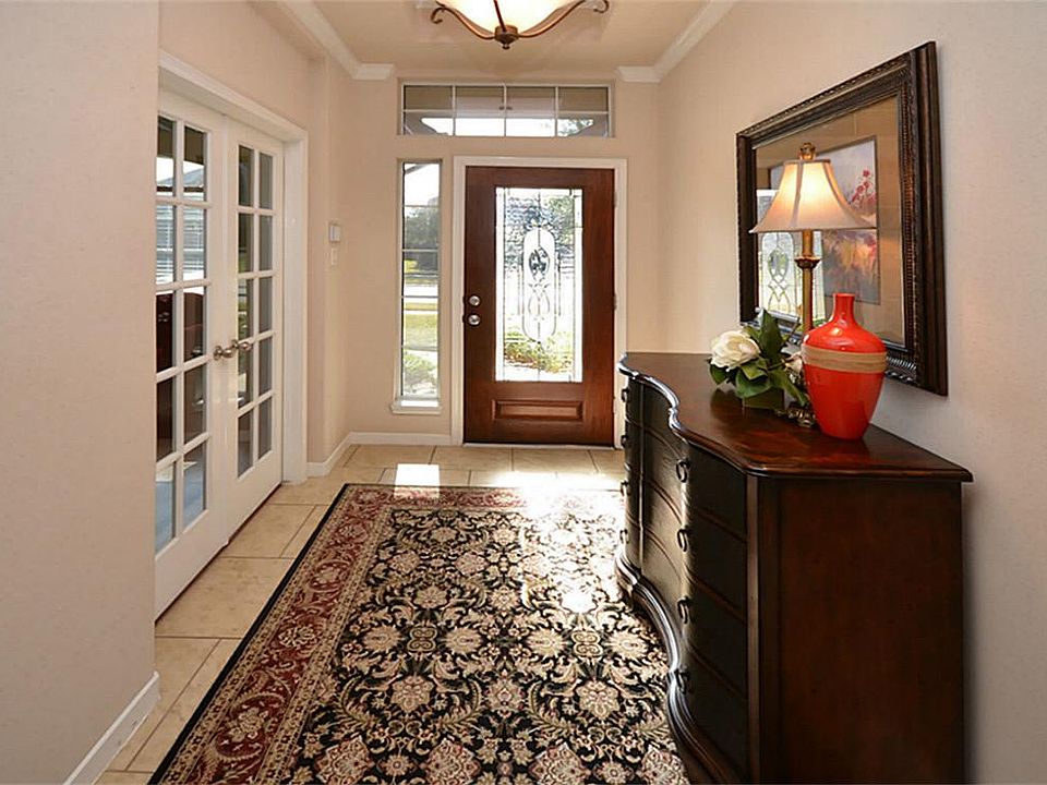 Entry way with detailed ceiling treatment, tile flooring and leaded glass front door.