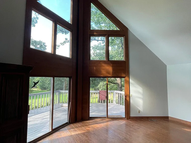 Inside living room. Notw wood molding and floors.