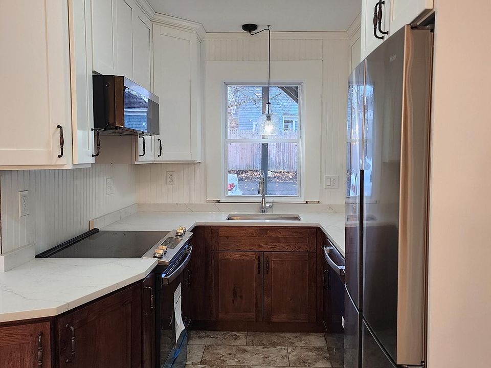 Cook's kitchen with new Energy Star stainless appliances, quartz counters, solid wood cabinetry, new laminate, easy-care flooring, counter-depth fridge, range, dishwasher and microwave