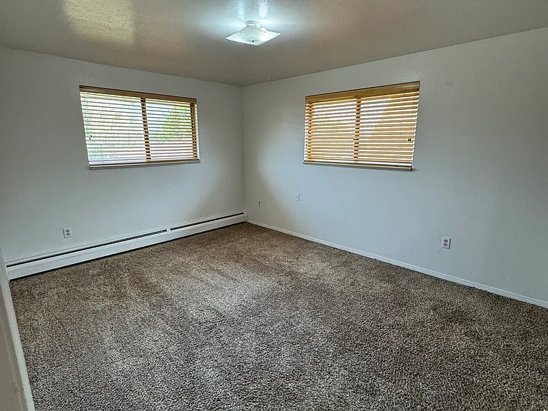South bedroom newer wood blinds, paint and newer carpet.