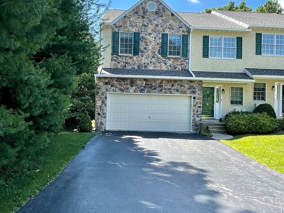 Beautiful End unit with 2 car garage and big driveway offering parking for several cars