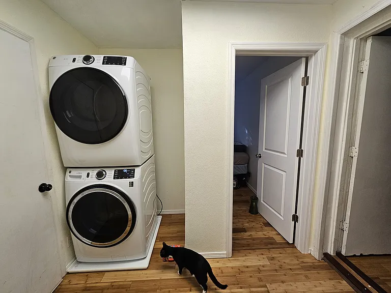 Laundry area next to back door (on left). Door on right opens into the 3rd bedroom.