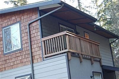 Covered deck off the upper bedroom gets the afternoon filtered sun. Lovely place to read.