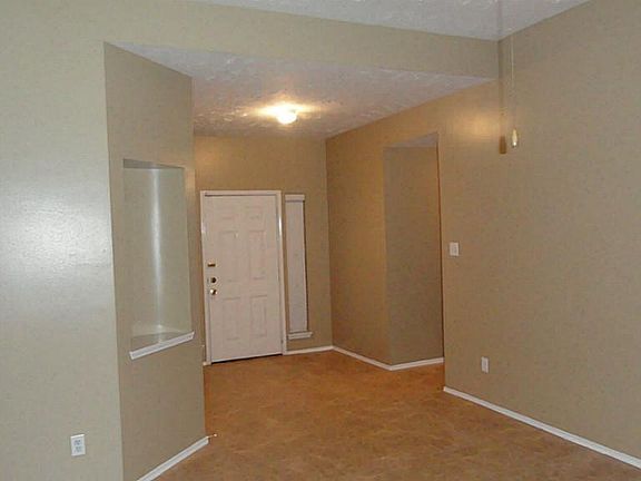 The entry is very inviting.  The warm tones of the walls and tile flooring will work with any color scheme.