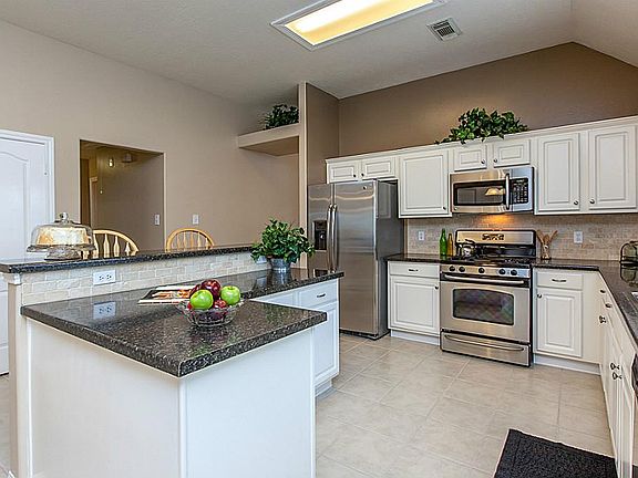 LARGE UPDATED KITCHEN WITH STAINLESS STEEL APPLIANCES & EXTENSIVE TILE FLOORING ~