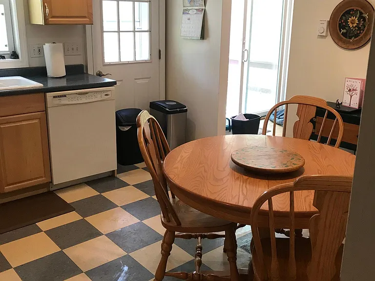 Another view of kitchen showing rear entry door.