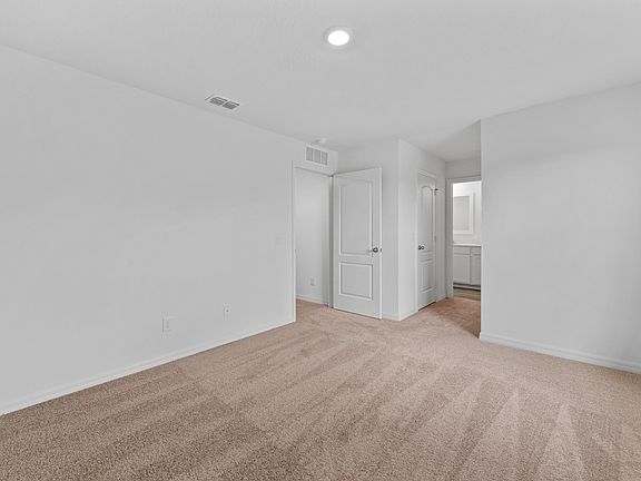 The master bedroom is spacious with two walk-in closets and access to its own bathroom