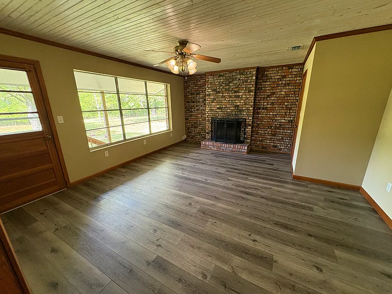 Den or office with wood burning fireplace