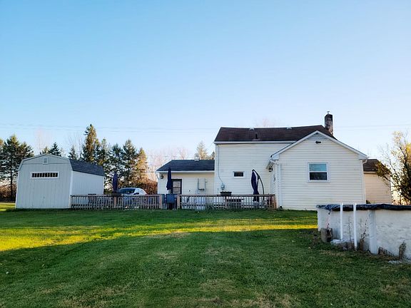 back patio and above ground pool.