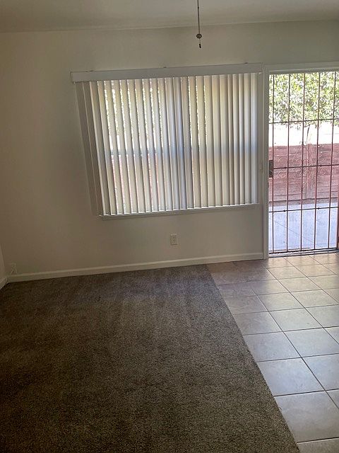 Front of apartment with large window and security screen. open floor plan