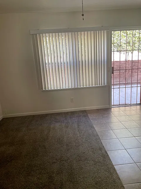 Front of apartment with large window and security screen. open floor plan