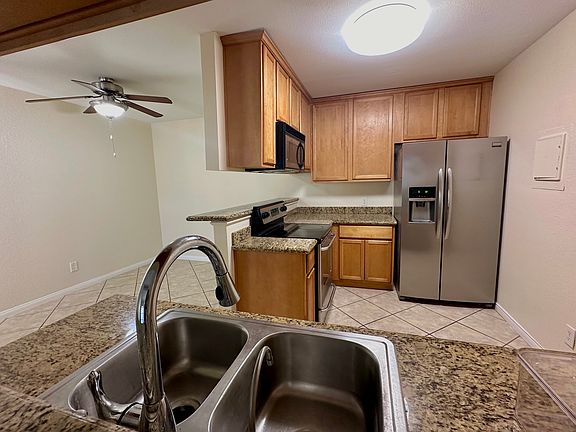 Kitchen has lovely granite countertops and stainless steel appliances