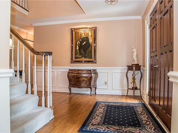 You will be proud to welcome guests into your home! The foyer features hardwood floors, chair rail and crown molding and leads t