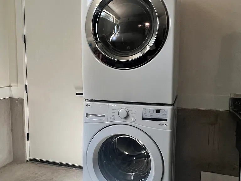 Tenant has an access to the washer & dryer in owner's garage.