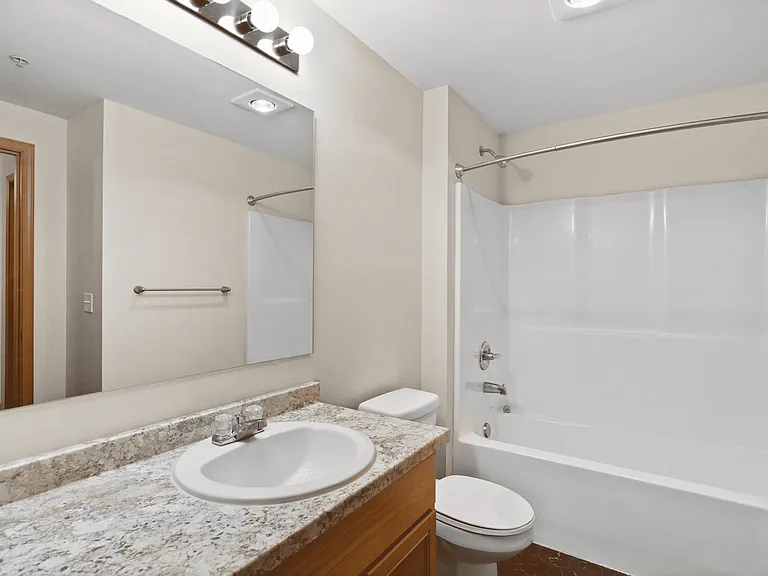 Bright bathroom with updated finishes and full tub/shower setup. Bright bathroom with updated finishes and full tub/shower setup.