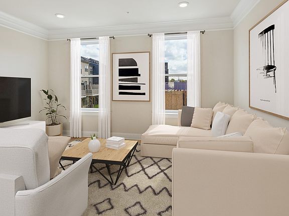 Family room with LVP floors and large windows in a DRB Homes Edson II at Vista Gardens West