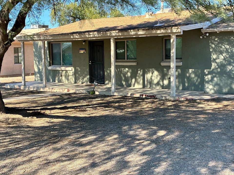 Front and to the right of the house