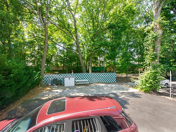 Enclosed backyard surrounded by greenery, located next to the Community Bike Path. Back entrance is primary used.