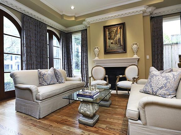 Formal living room with high ceilings, hardwoods, and fireplace
