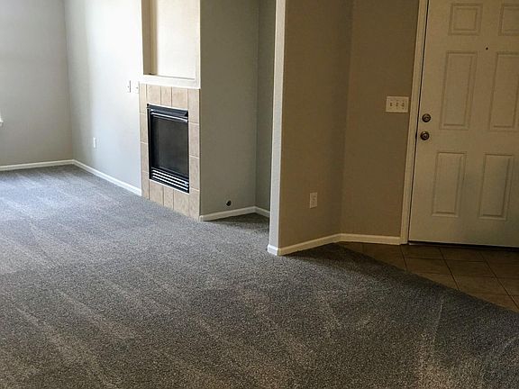 Entry into living room w/ fireplace.