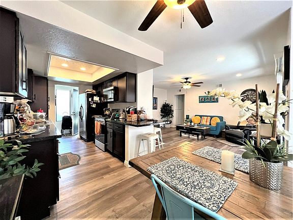 Dining room, kitchen and living room from dining room corner.