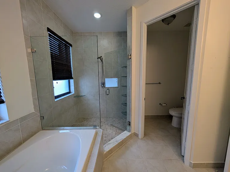 Master bedroom shower and sectioned toilet