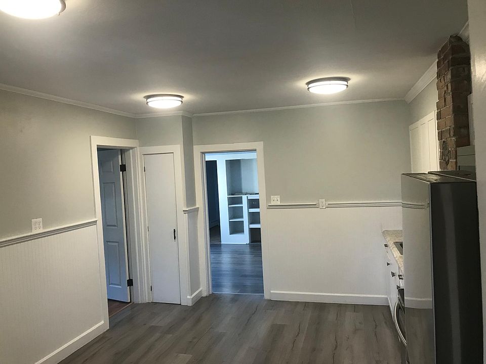 Bedroom door on left, living room ahead.