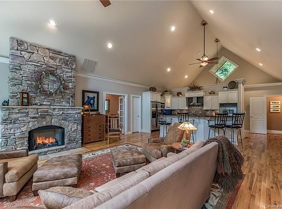 Hardwood floors in living room, kitchen an dining room.  Floor to ceiling stone fireplace.