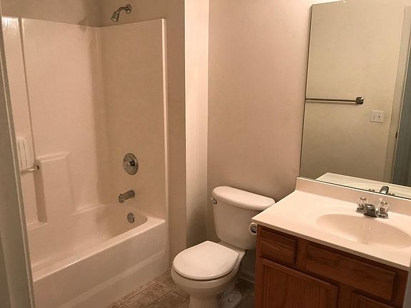 Hall bath has new towel hooks clear shower curtain that_s ne