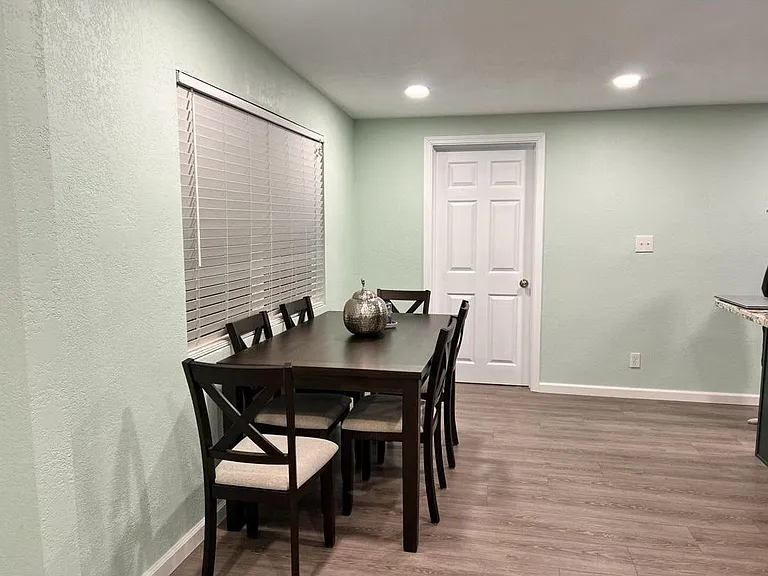 Dedicated dining area with a full-size table, overhead recessed lighting, and easy access to the adjacent kitchen.