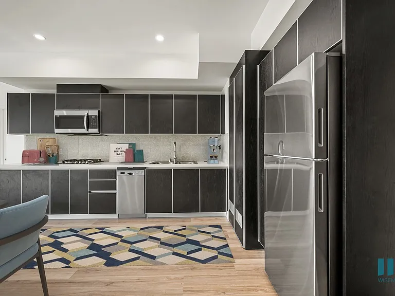Open-Concept Kitchen with a Stainless-Steel Refrigerator, Dishwasher, Stove Range, and Microwave Oven - Oak Floor Plan