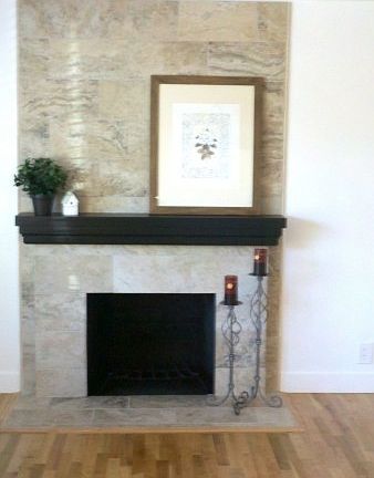 Living room with beautifully tiled wood burning fireplace and refinished hardwood floors.