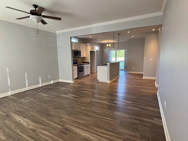 Living room area open to kitchen area