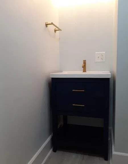 Modern blue vanity with gold accessories.