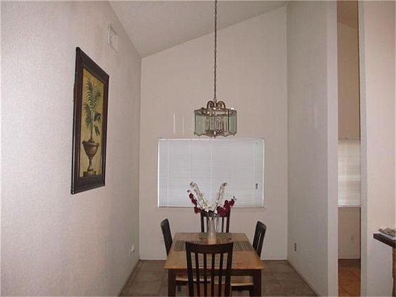 DINING ROOM ALSO HAS HIGH CEILINGS AND TILE FLOORING