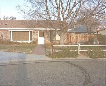 Front view with fencing and trees