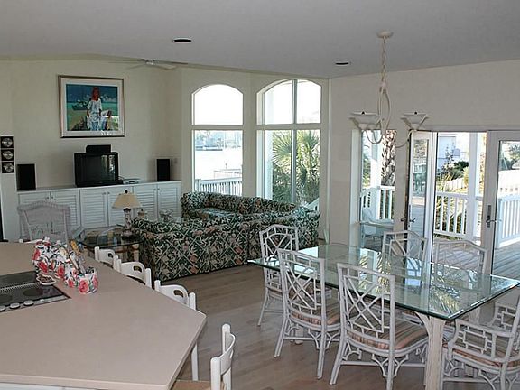 Open concept in dining, kitchen and living area. Furnishings remain except for art work.