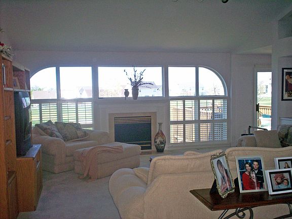 Wall of windows surrounds the marble fireplace