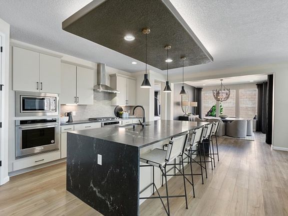 Award-winning Parklane home design is popular for the open gathering room, kitchen, cafe, and patio